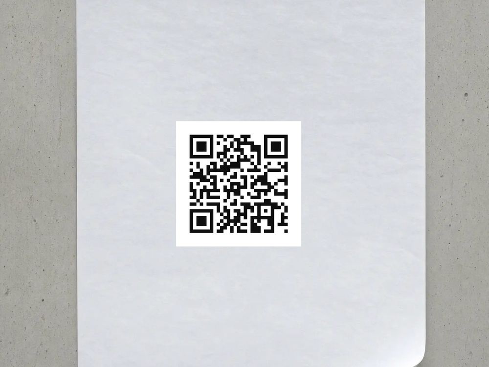 A paper poster taped to a concrete wall, carrying the code